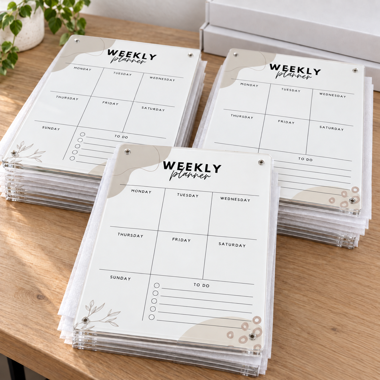 Stacks of branded MUKA acrylic weekly planners packed for a corporate order