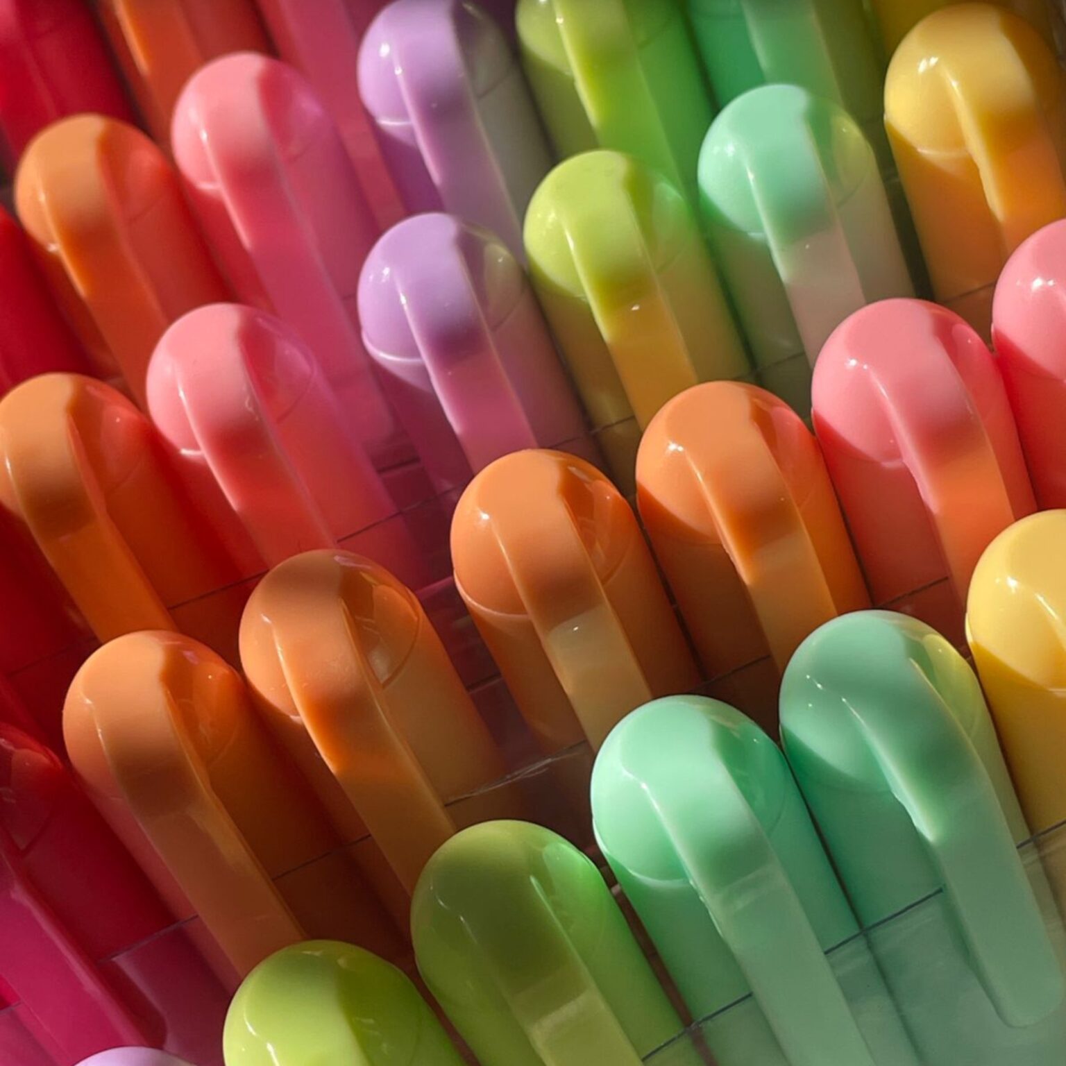 Coloured dry-wipe markers laid out in a fan